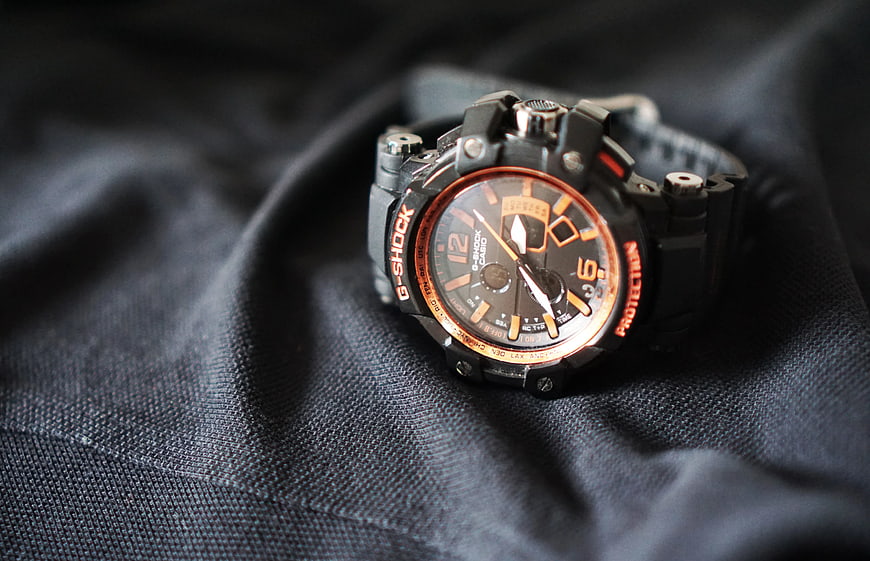 Black and Orange G-Shock Watch on Dark Fabric