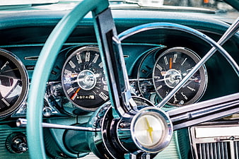 Vintage turquoise car dashboard and steering wheel interior