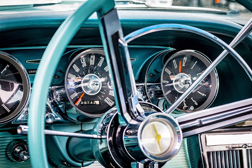 Vintage turquoise car dashboard and steering wheel interior