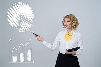 Businesswoman pointing at financial growth charts and graphs