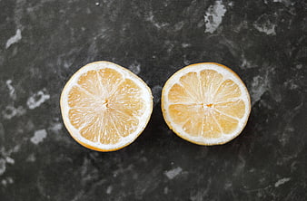 Sliced Lemon Halves on Dark Marble Background