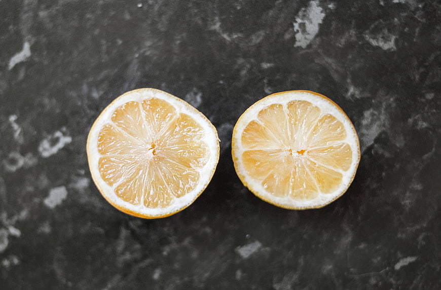 Sliced Lemon Halves on Dark Marble Background