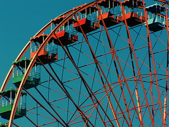 Colorful Ferris Wheel Against Blue Sky