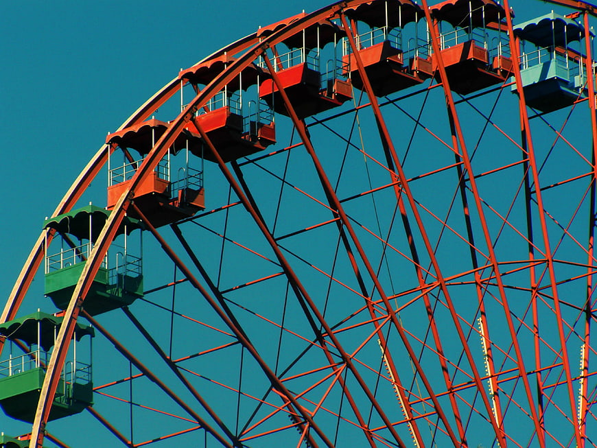 Colorful Ferris Wheel Against Blue Sky