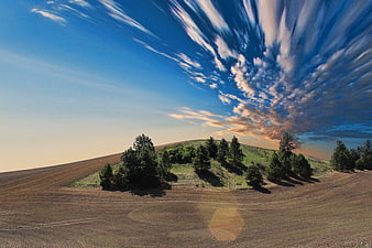 Dramatic rural landscape with plowed field and dynamic sky