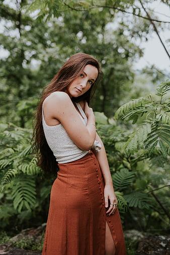 Woman in Rust Skirt and White Top in Lush Forest
