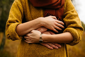 Close-up of woman hugging herself in autumn coat