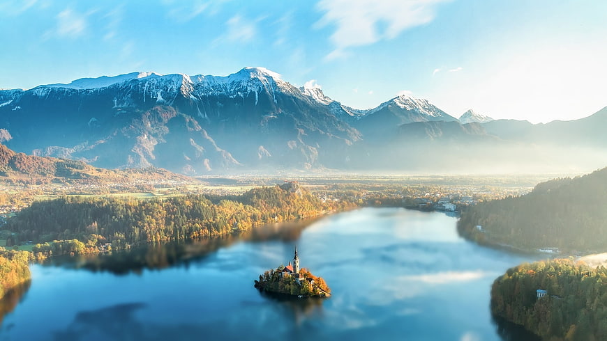 Aerial View of Lake Bled Island and Snowy Alps in Autumn