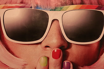 Close-up of woman with pink hair and rainbow sunglasses