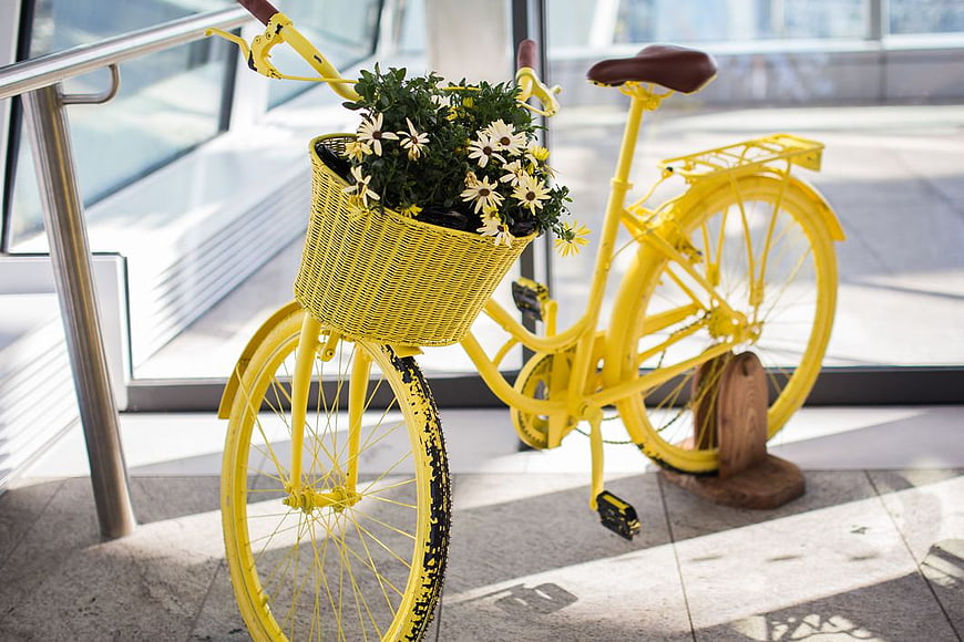 Yellow Bicycle with Daisy Flowers in Basket