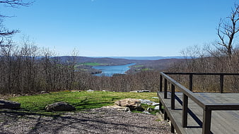 Scenic overlook with wooden deck and distant lake view