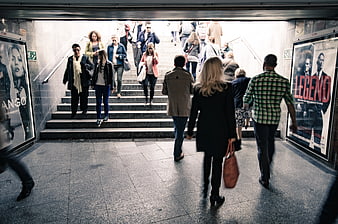 Crowd Walking Up Subway Stairs in Urban Setting