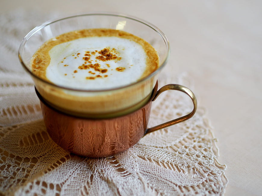 Turmeric Latte in Copper Mug on Lace Doily