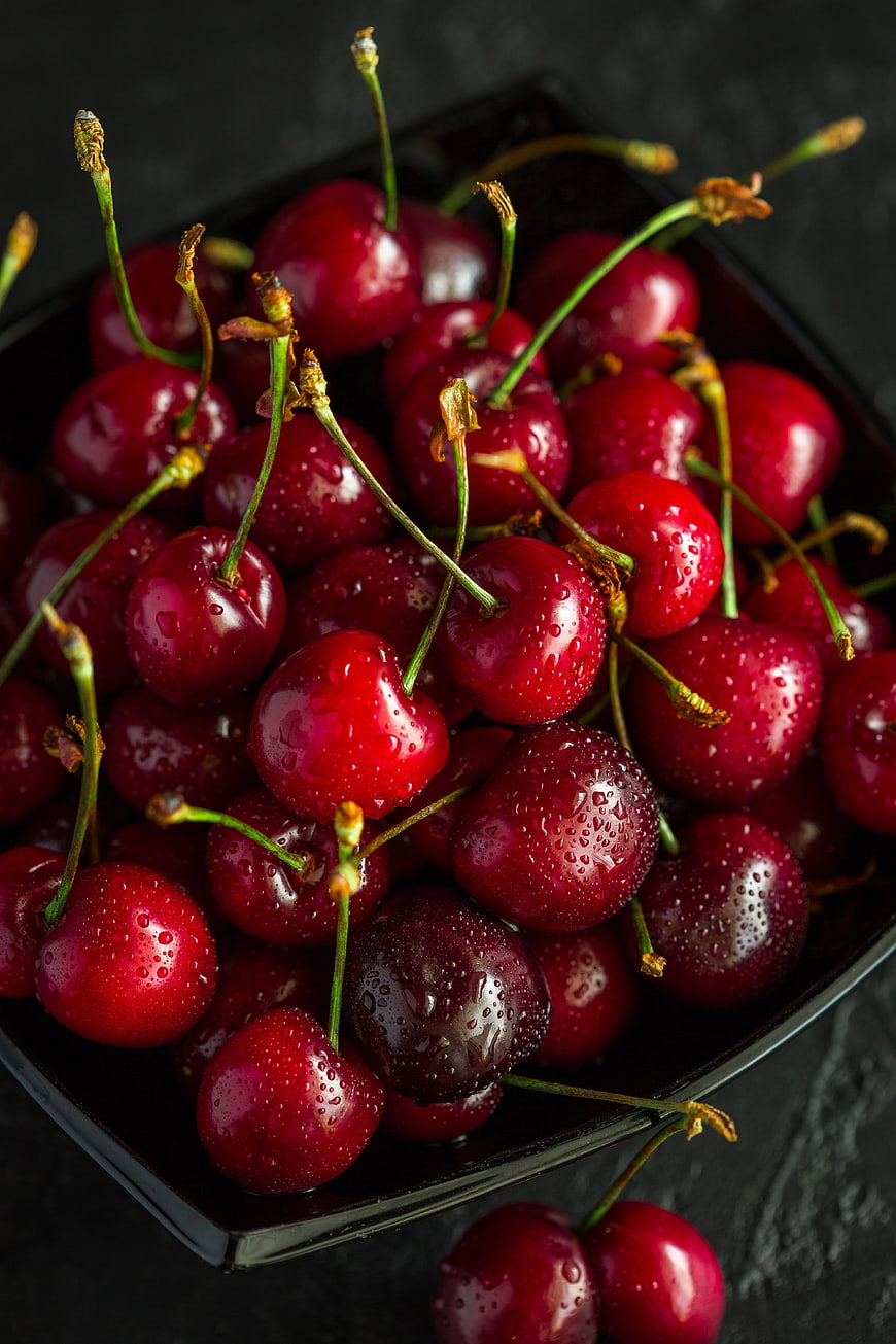 Fresh Wet Red Cherries in Black Bowl