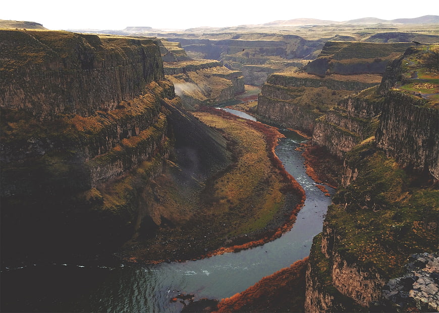 Aerial View of River Winding Through Dramatic Canyon Cliffs