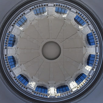 Symmetrical white architectural dome with blue glass windows