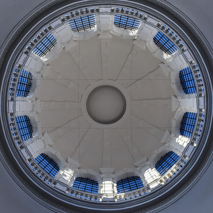 Symmetrical white architectural dome with blue glass windows