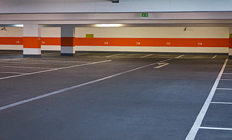 Empty multi-storey parking garage with orange and white walls