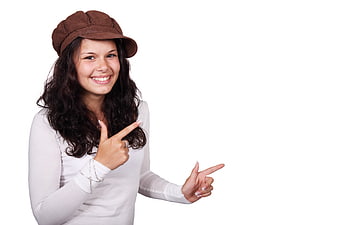 Young woman pointing to empty white space