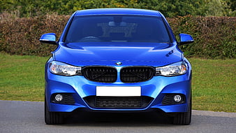 Front view of blue BMW 1 Series on road