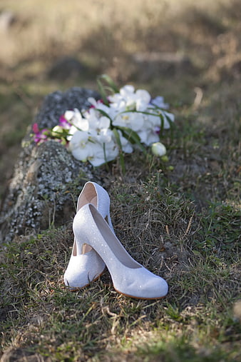 White Wedding Shoes and Bouquet on Grass