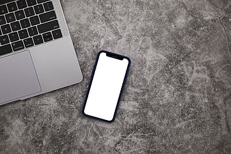 Smartphone and Laptop on Textured Concrete Background