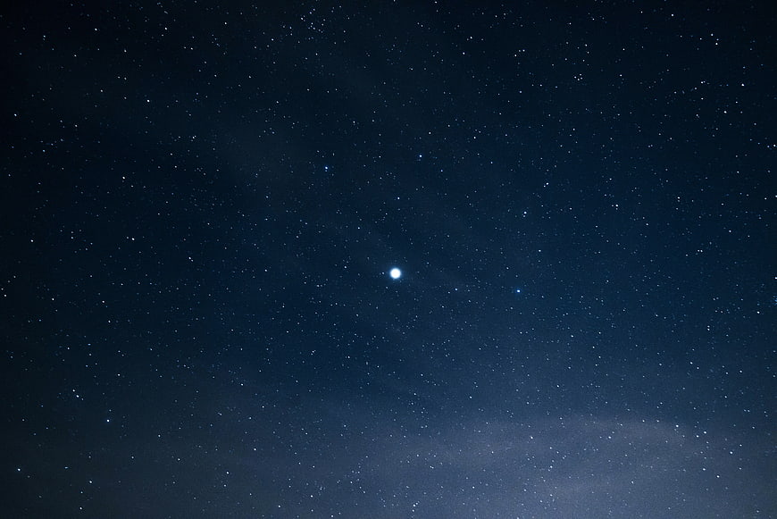 Bright Star in Deep Blue Night Sky with Milky Way