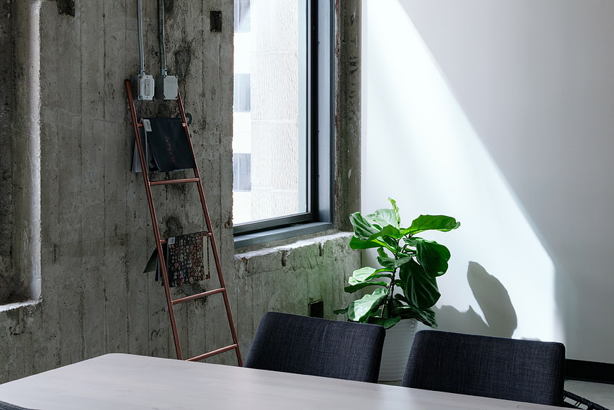 Modern industrial interior with concrete wall and sunlight