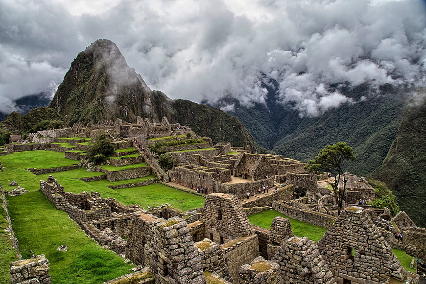 Machu Picchu ruins with Huayna Picchu mountain and clouds