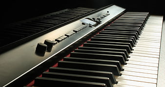 Close-up of black electronic keyboard with dramatic lighting
