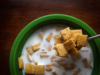 Close-up of Corn Flakes Cereal in Green Bowl with Milk