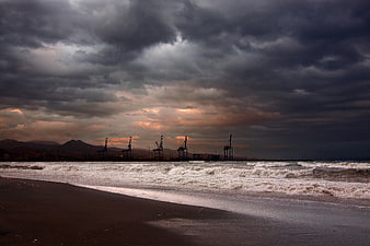 Dramatic Stormy Sky Over Industrial Port and Beach