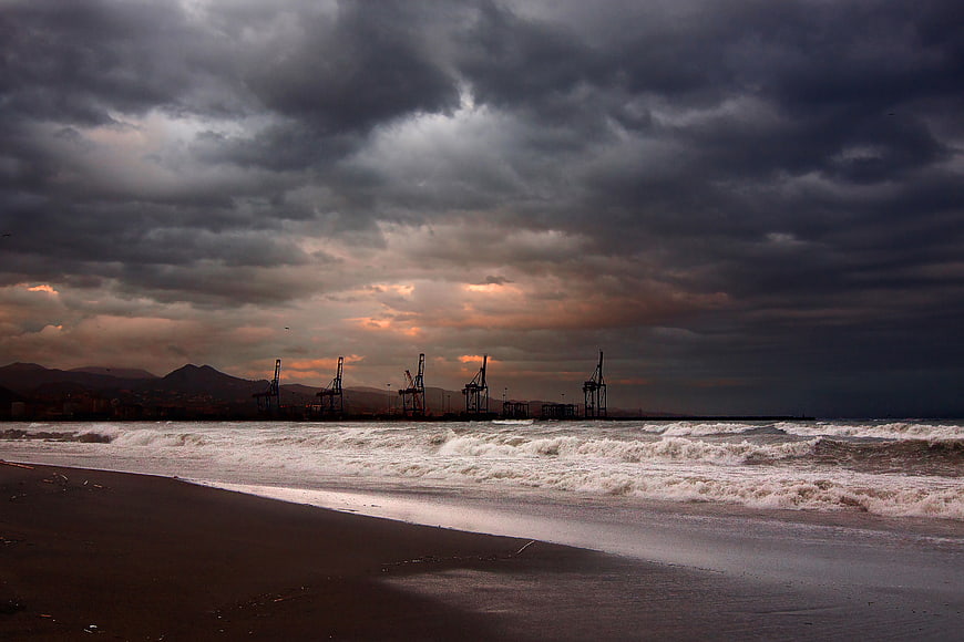 Dramatic Stormy Sky Over Industrial Port and Beach