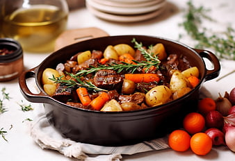 Hearty Beef Stew with Potatoes and Carrots in Cast Iron Pot