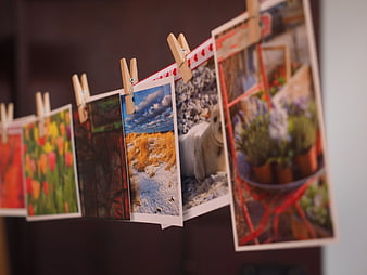 Polaroid photos hanging on a clothesline with wooden clips