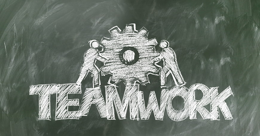 Chalkboard drawing of teamwork concept with gears and people