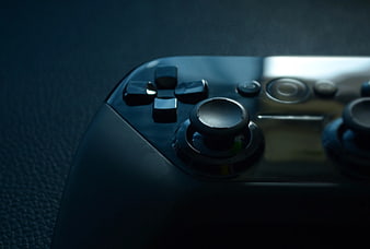Close-up of black game controller on textured surface