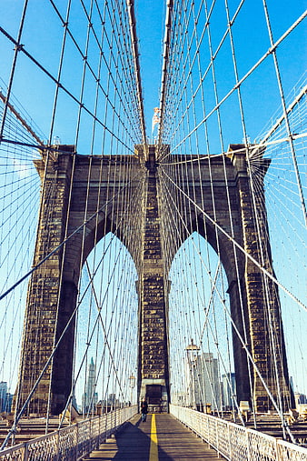 Low angle view of Brooklyn Bridge stone tower and cables