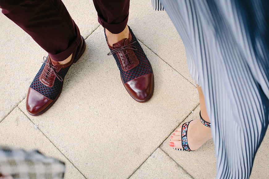 Couple's stylish shoes on pavement, fashion detail