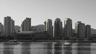 Black and white Vancouver skyline with boats on water