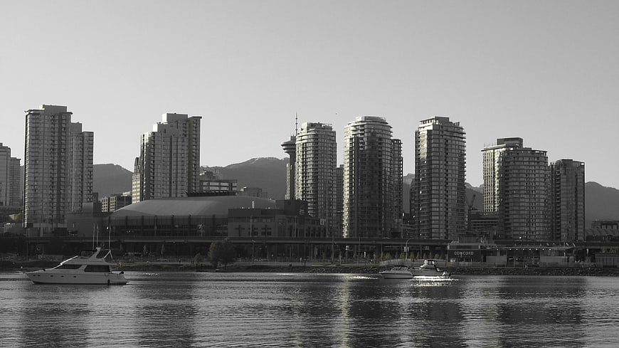Black and white Vancouver skyline with boats on water