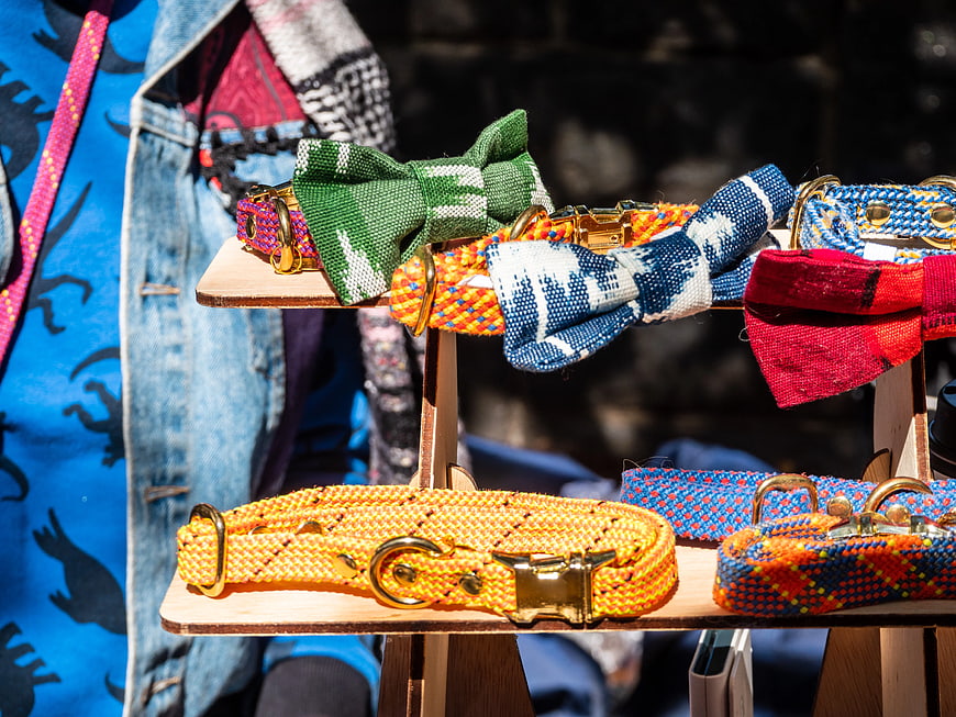 Colorful Woven Dog Collars and Bow Ties on Wooden Stand