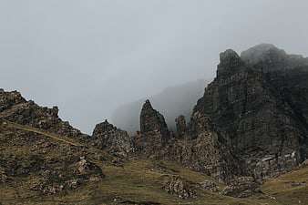Misty Rocky Mountain Peaks in Highland Landscape