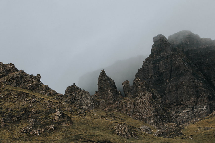 Misty Rocky Mountain Peaks in Highland Landscape