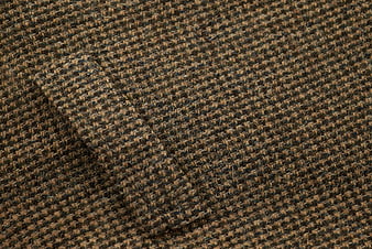 Close-up of brown and black wool suit fabric texture