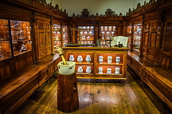 Historic Antique Pharmacy Interior With Wooden Cabinets And Ceramic Jars
