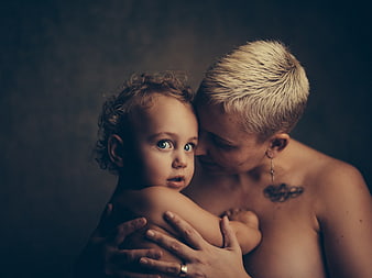 Emotional Portrait of Mother Holding Toddler with Blue Eyes
