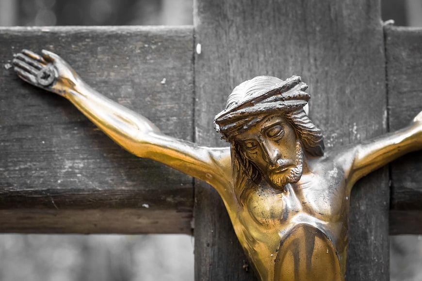 Golden Jesus Christ Statue on Weathered Wooden Cross