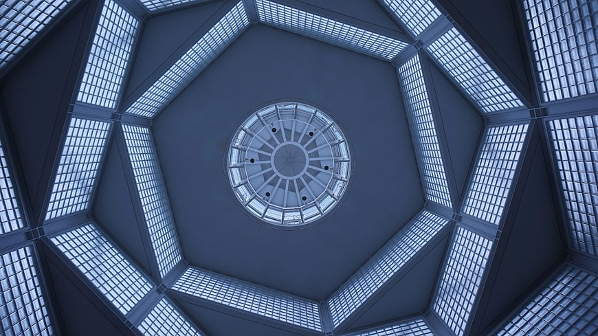Hexagonal skylight ceiling with geometric blue architectural pattern