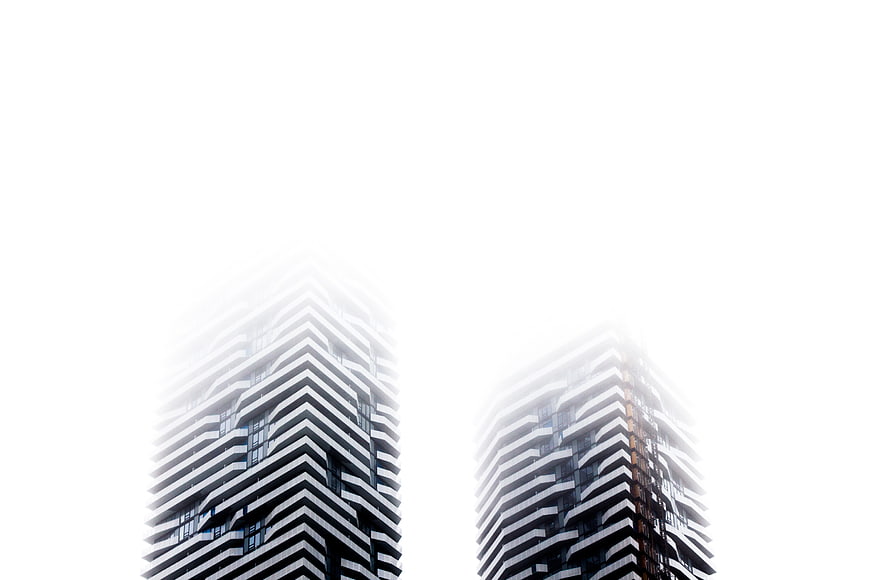 Modern Skyscrapers Vanishing into Thick White Fog